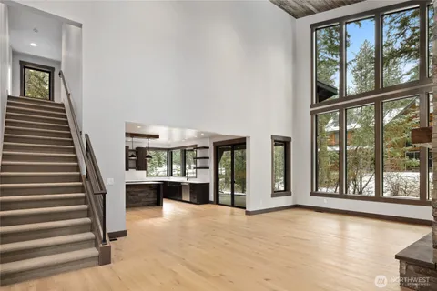 a view of a living room with furniture and staircase