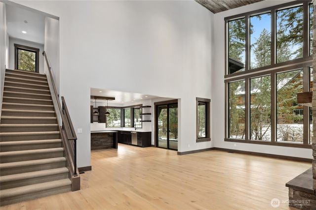 a view of a living room with furniture and staircase