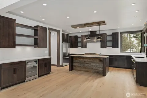 a kitchen with stainless steel appliances kitchen island granite countertop a stove and a sink