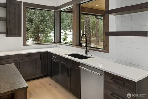 a kitchen with a sink and large window