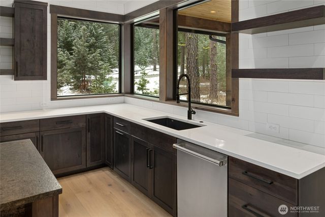 a kitchen with a sink and large window