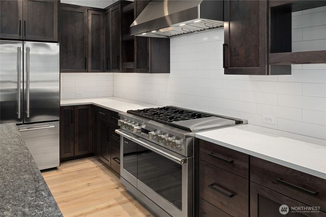 a kitchen with a stove and a refrigerator