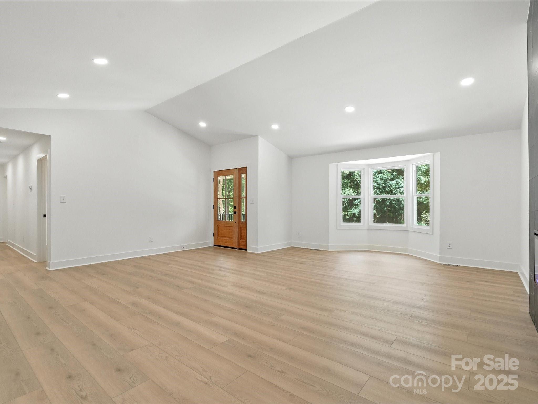 3303 Reid Circle Monroe, NC 28112 - Photo 16 of 44 an empty room with wooden floor and windows