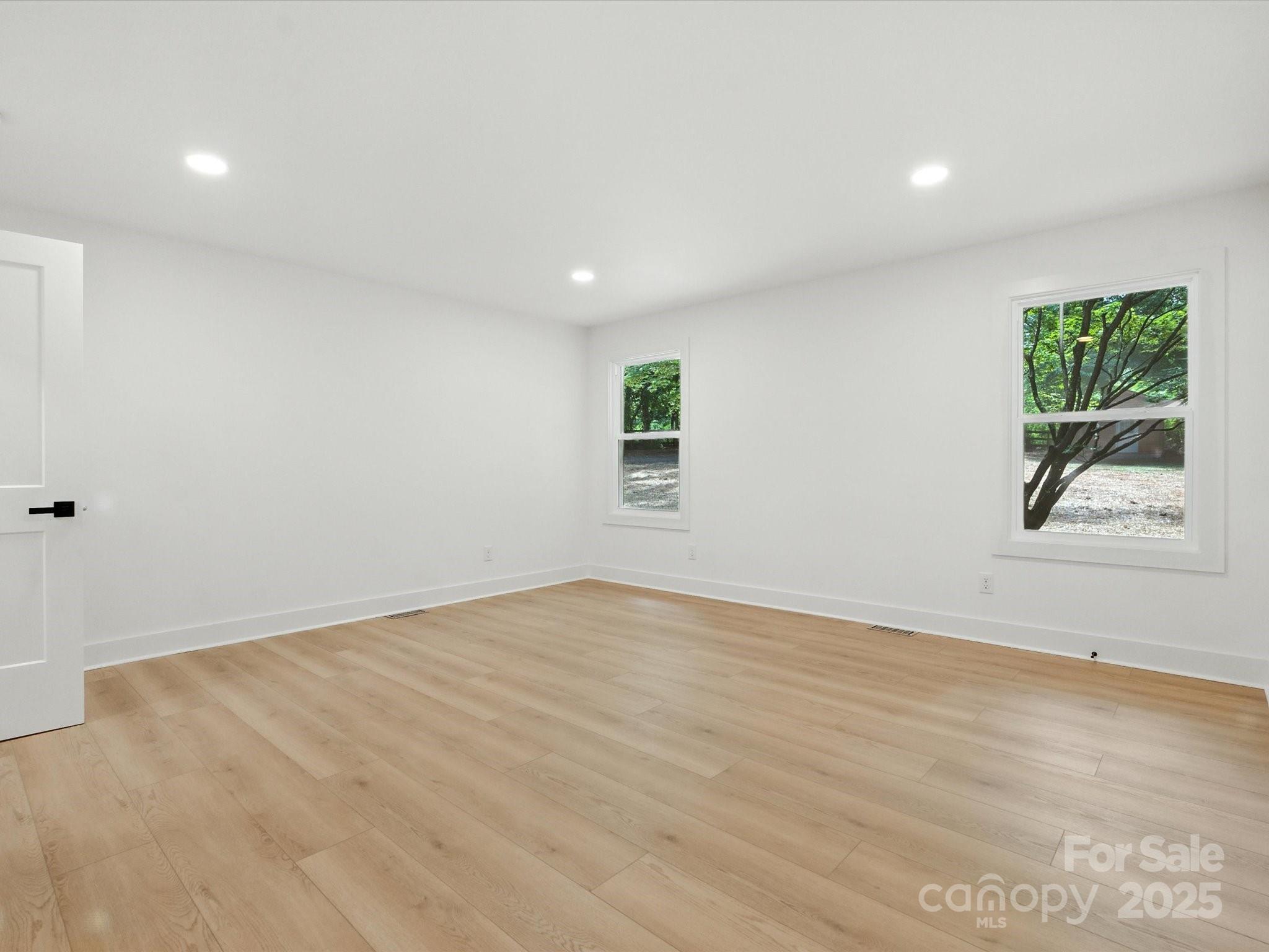 3303 Reid Circle Monroe, NC 28112 - Photo 20 of 44 a view of an empty room with wooden floor and a window