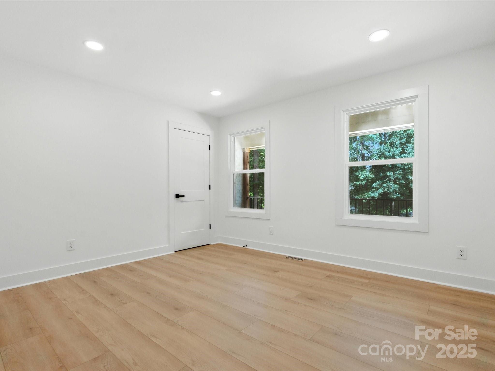 3303 Reid Circle Monroe, NC 28112 - Photo 22 of 44 a view of an empty room with wooden floor and a window