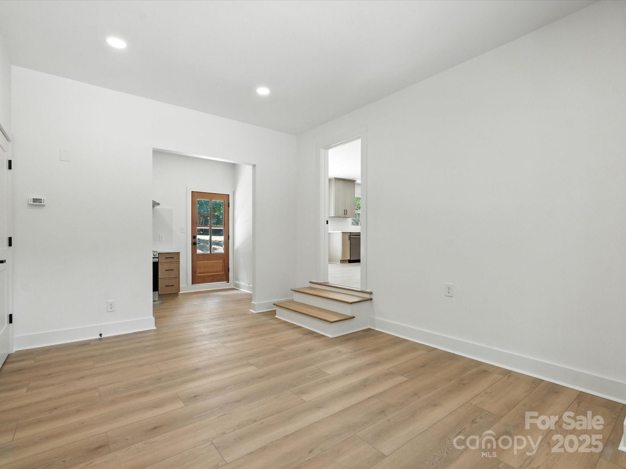3303 Reid Circle Monroe, NC 28112 - Photo 25 of 44 wooden floor in an empty room with a window