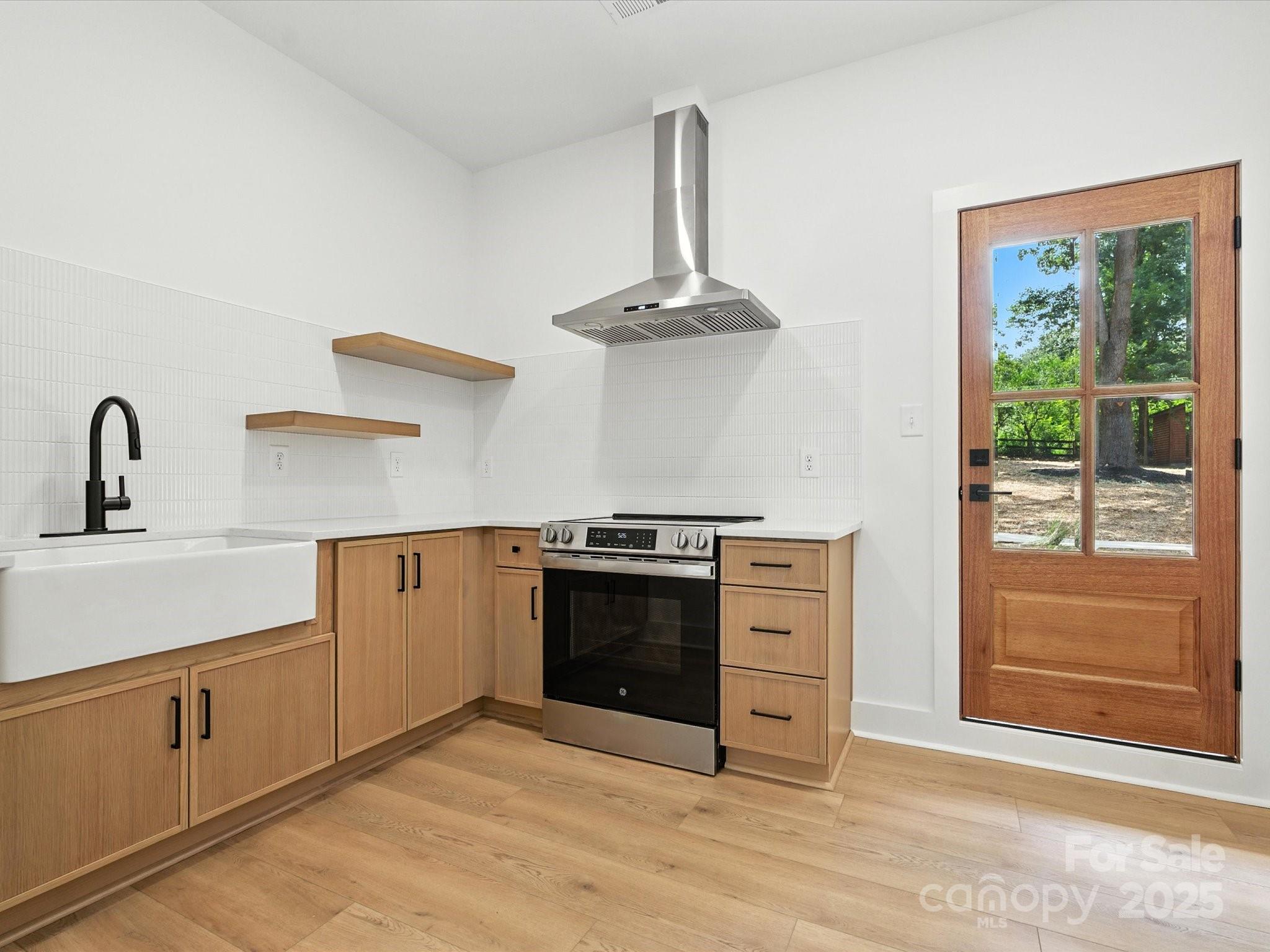 3303 Reid Circle Monroe, NC 28112 - Photo 27 of 44 a kitchen with a stove and a sink