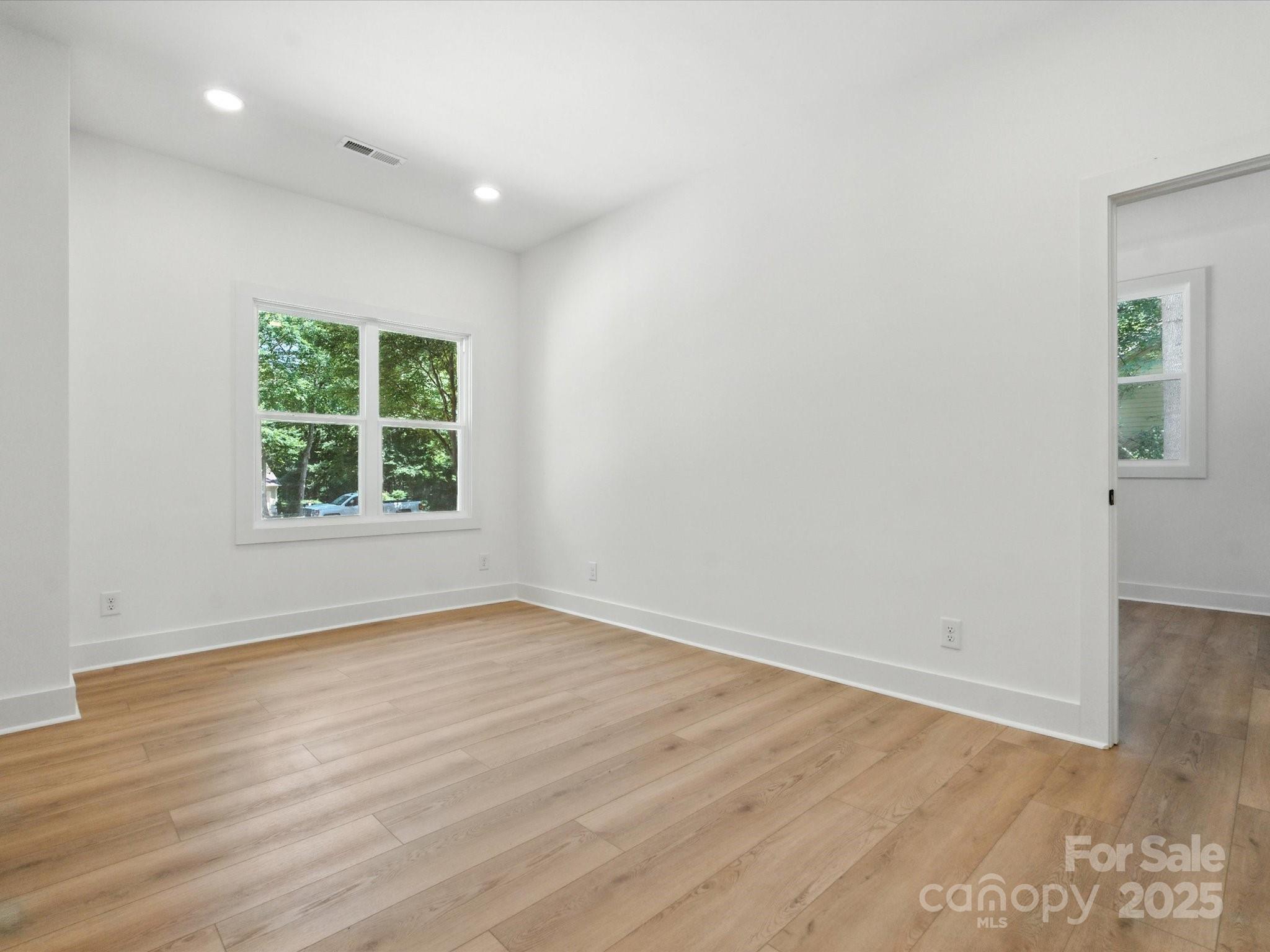 3303 Reid Circle Monroe, NC 28112 - Photo 28 of 44 an empty room with wooden floor and windows