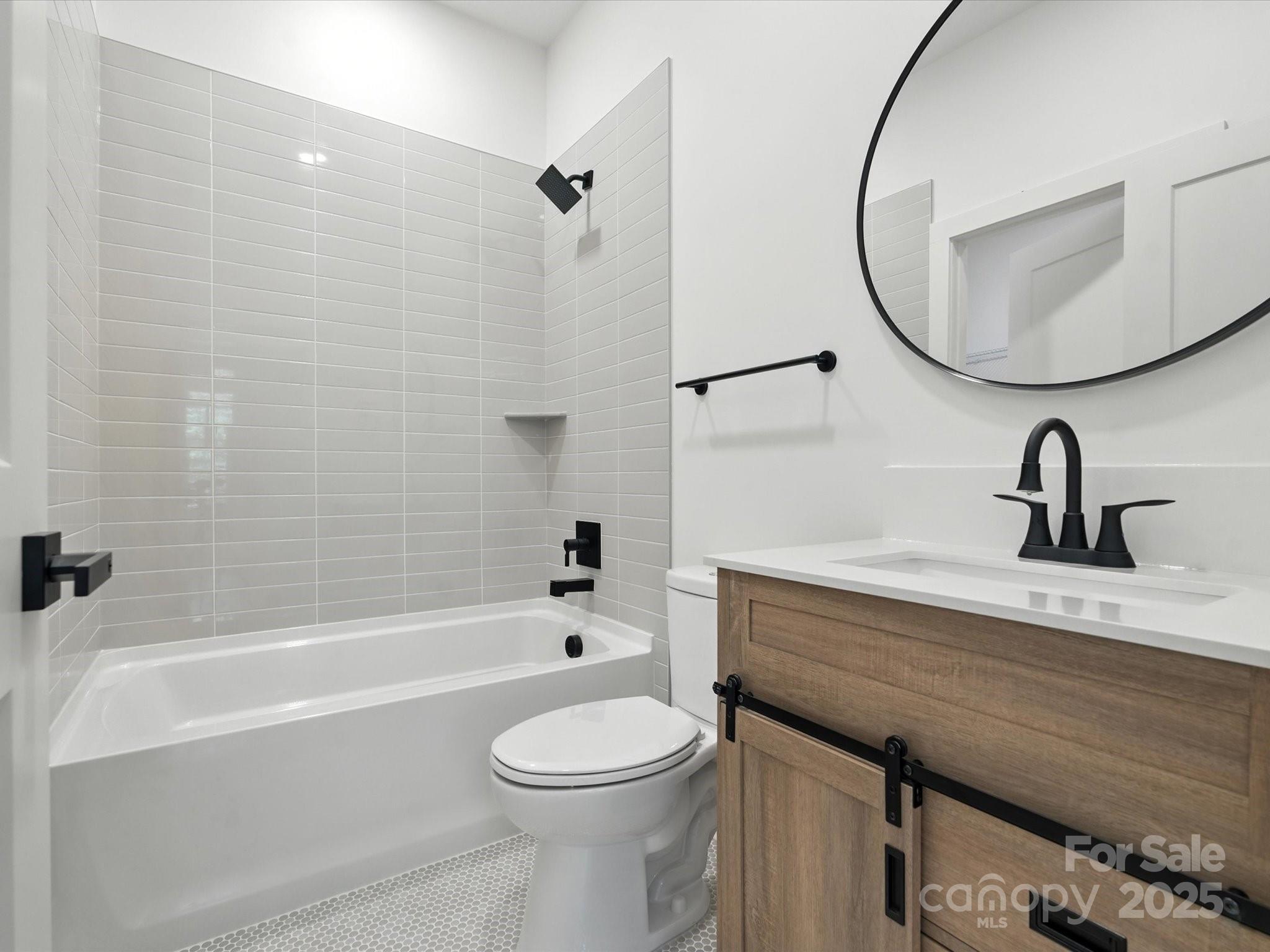 3303 Reid Circle Monroe, NC 28112 - Photo 29 of 44 a bathroom with a sink a toilet and a mirror