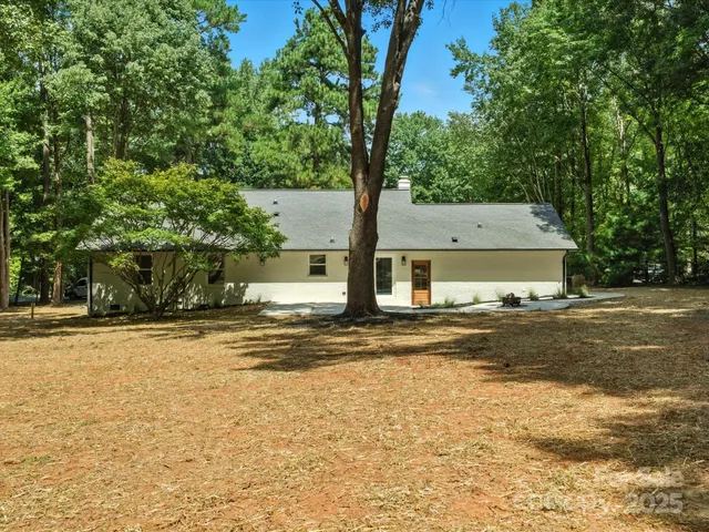a swimming pool with trees in the background