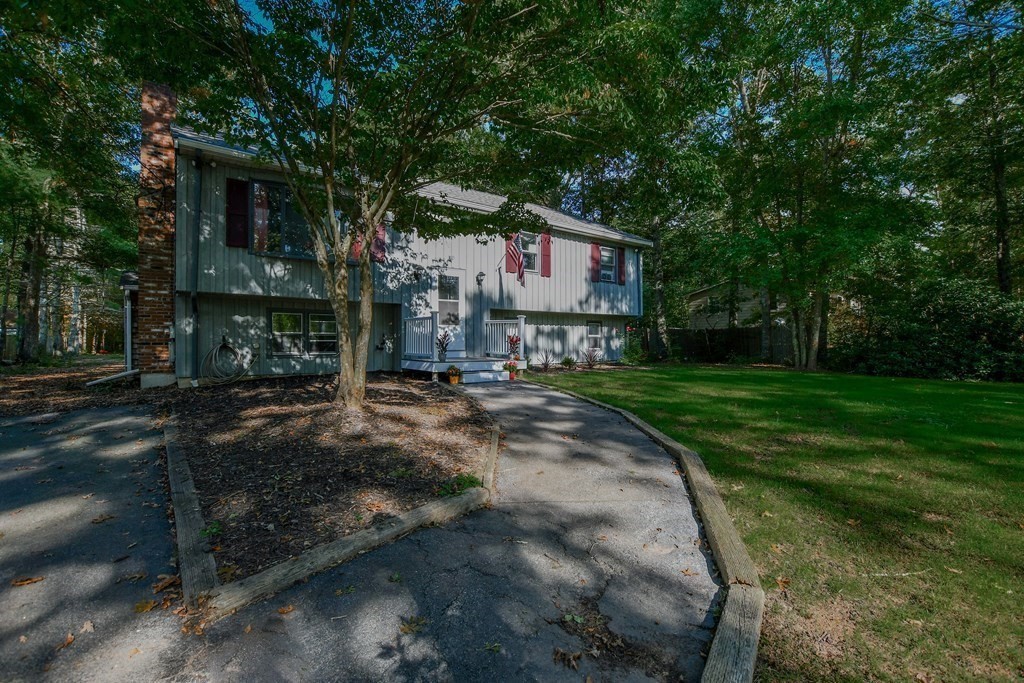 63 Papermill Road Wareham, MA 02576 - Photo 1 of 42 a pathway of a house with a yard
