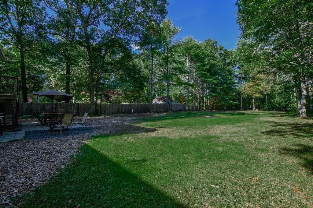 63 Papermill Road Wareham, MA 02576 - Photo 6 of 42 a view of backyard with table and chairs a fire pit and a trees