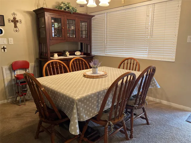 a dining room with furniture and window