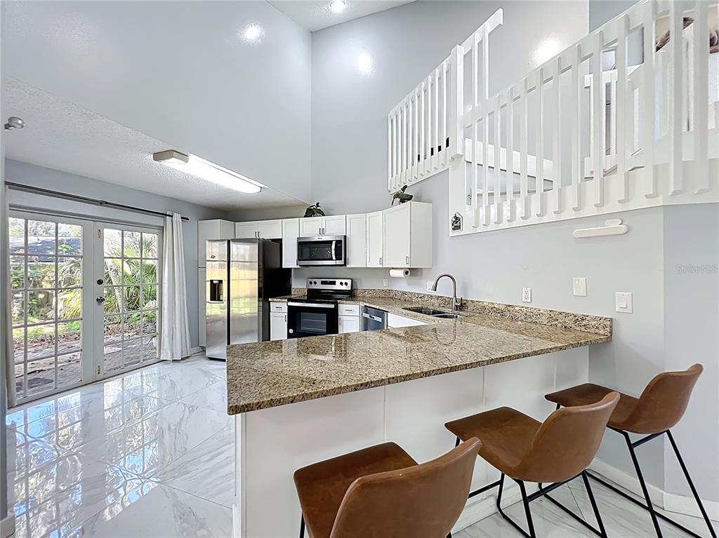 622 Anhinga Road Winter Springs, FL 32708 - Photo 11 of 53 a kitchen with stainless steel appliances granite countertop a sink and cabinets