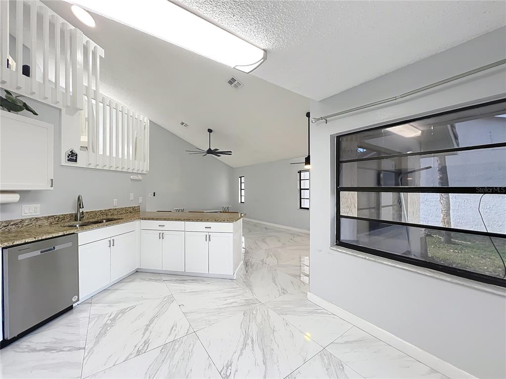 622 Anhinga Road Winter Springs, FL 32708 - Photo 14 of 53 a large white kitchen with a sink and cabinets
