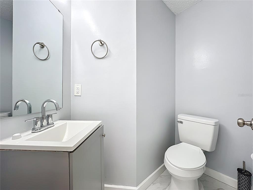 622 Anhinga Road Winter Springs, FL 32708 - Photo 21 of 53 a bathroom with a toilet sink and mirror