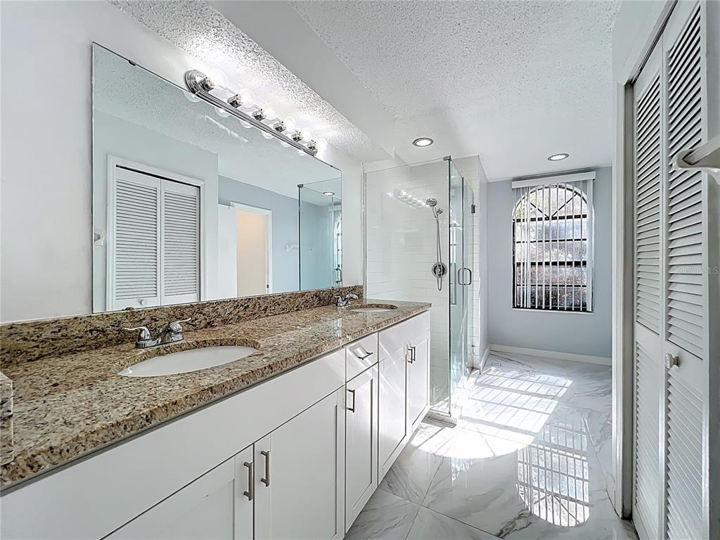 622 Anhinga Road Winter Springs, FL 32708 - Photo 25 of 53 a bathroom with a granite countertop sink mirror and a shower