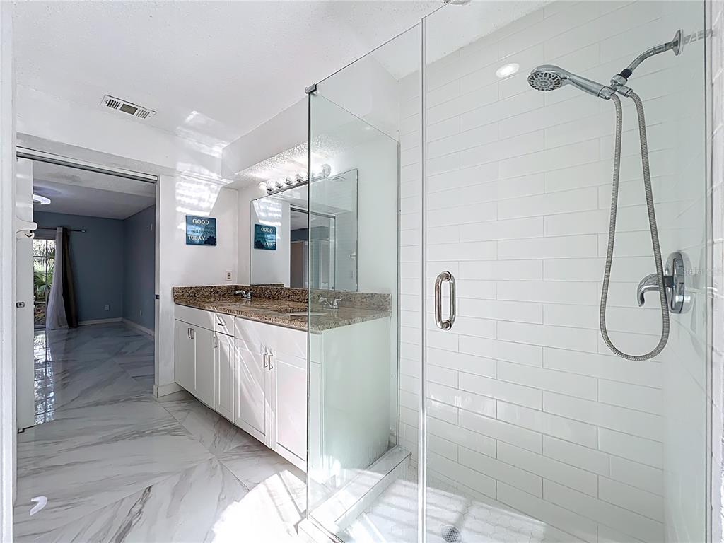 622 Anhinga Road Winter Springs, FL 32708 - Photo 26 of 53 a bathroom with a granite countertop sink mirror and shower