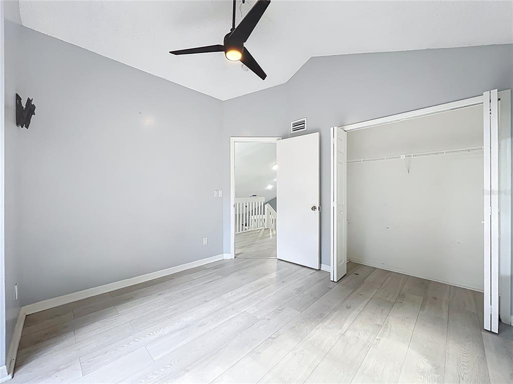 622 Anhinga Road Winter Springs, FL 32708 - Photo 32 of 53 an empty room with an entryway and wooden floor