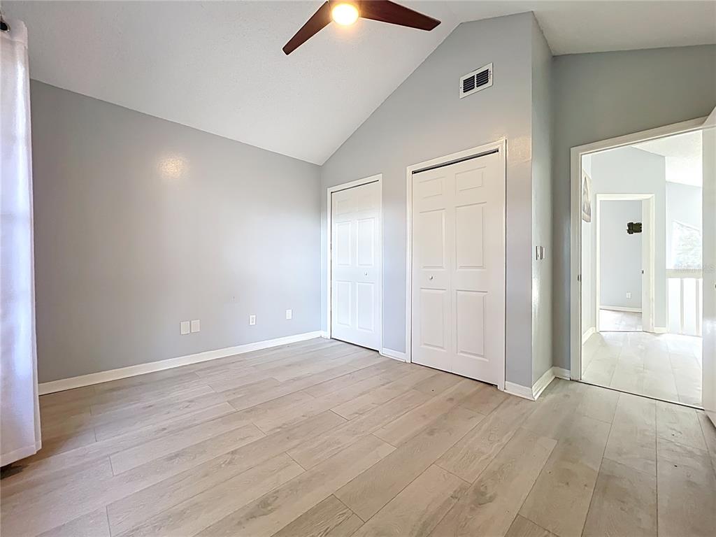 622 Anhinga Road Winter Springs, FL 32708 - Photo 33 of 53 a view of an empty room with wooden floor and a ceiling fan