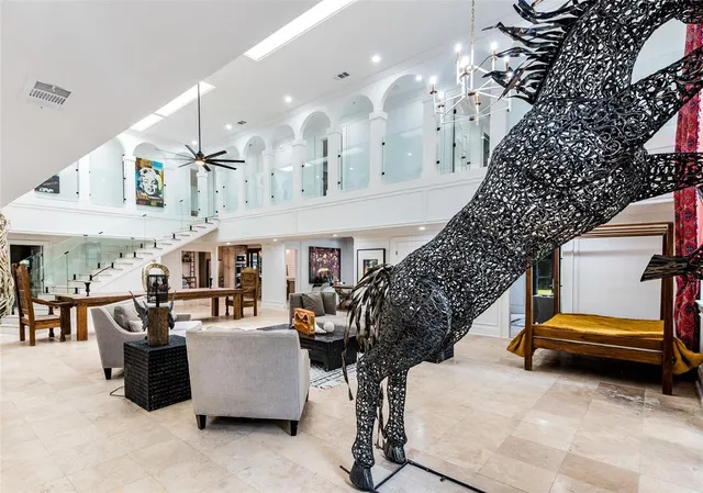 a living room with furniture and a chandelier