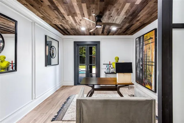 a living room with furniture and large windows