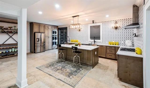 a kitchen with a sink a stove and chairs