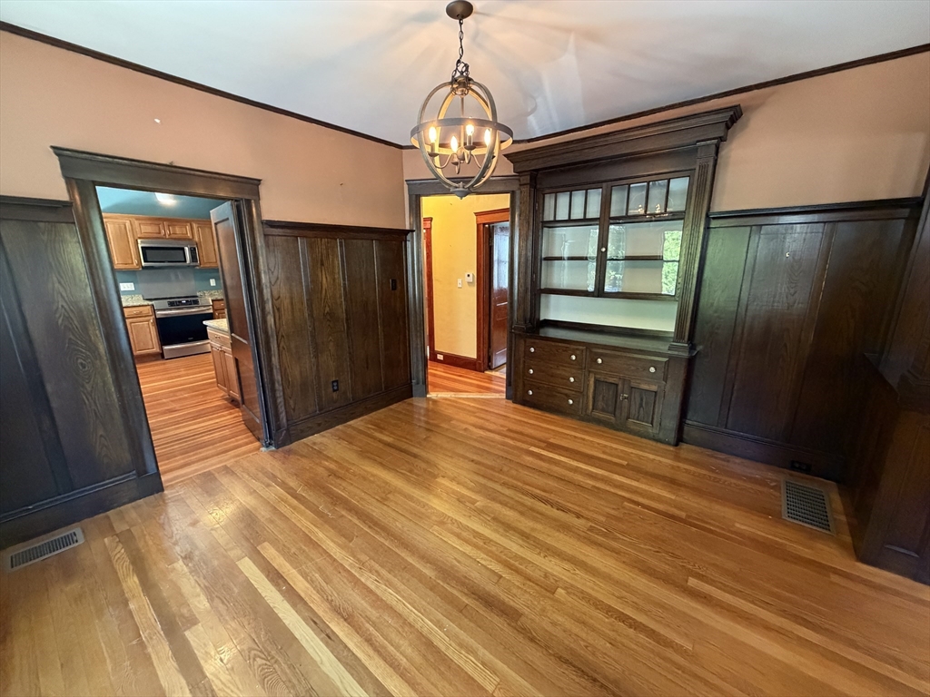 12-14 Warwick Road, Unit 12 Belmont, MA 02478 - Photo 9 of 15 a bedroom with a bed and a mirror