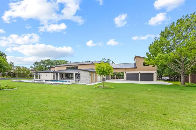 a view of an empty room with a window and kitchen view