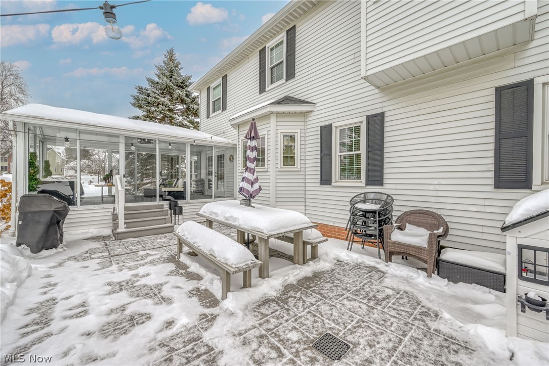 3912 Raintree Circle Uniontown, OH 44685 - Photo 39 of 49 View of patio featuring a sunroom, grilling area, and outdoor dining space