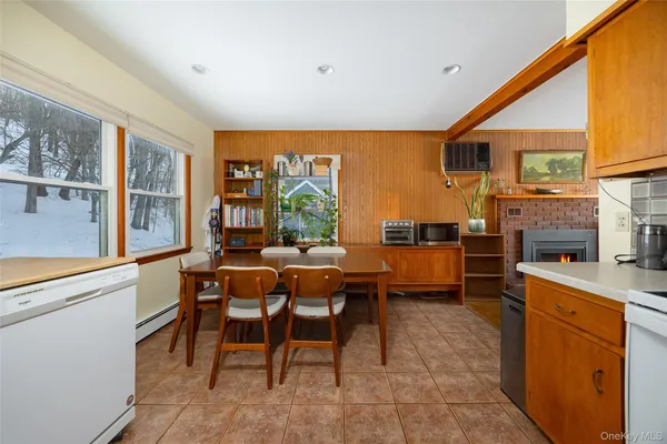 a dining room with furniture and a kitchen view
