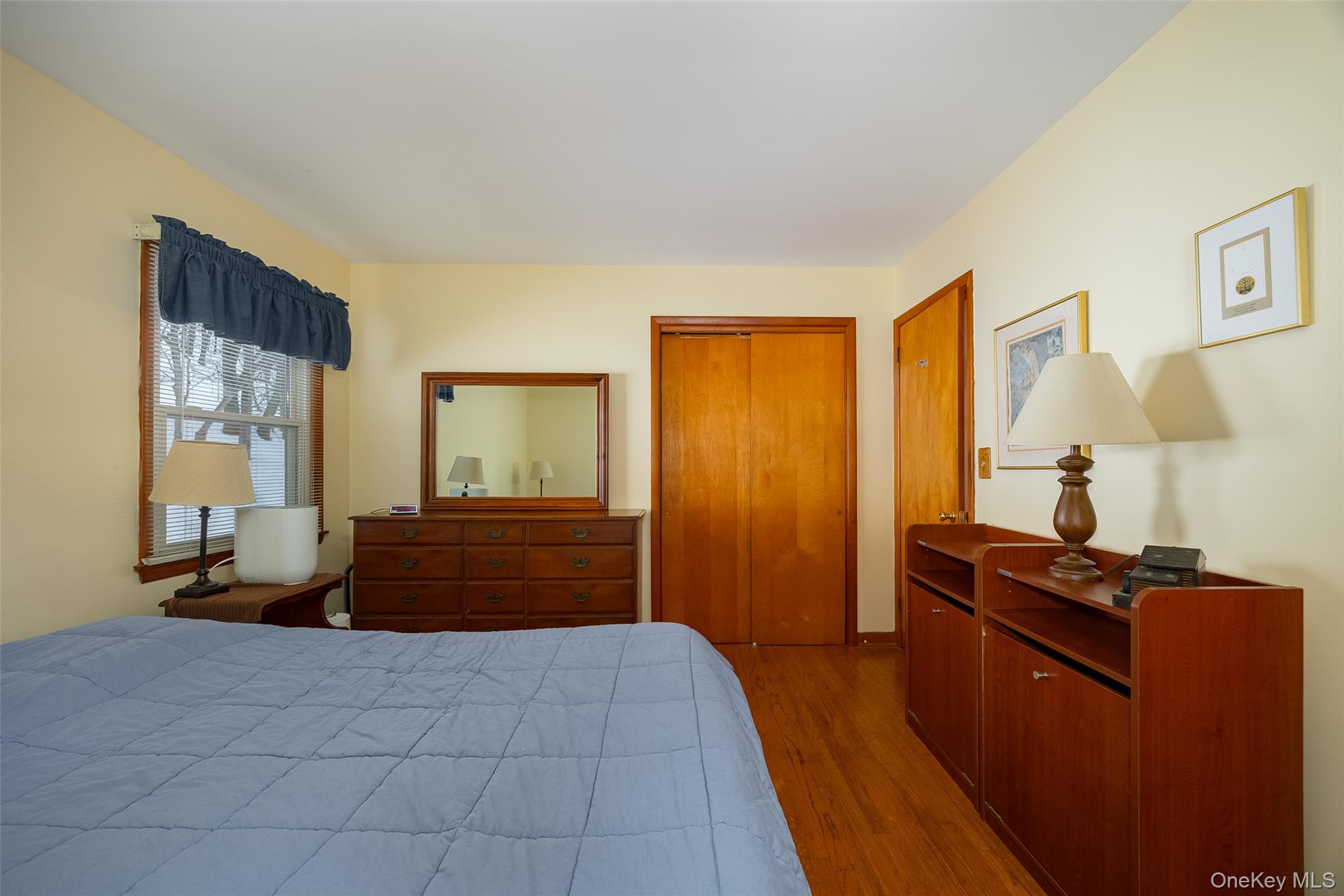 563 Spring Lake Road Red Hook, NY 12571 - Photo 9 of 33 a bedroom with a bed and wooden floor