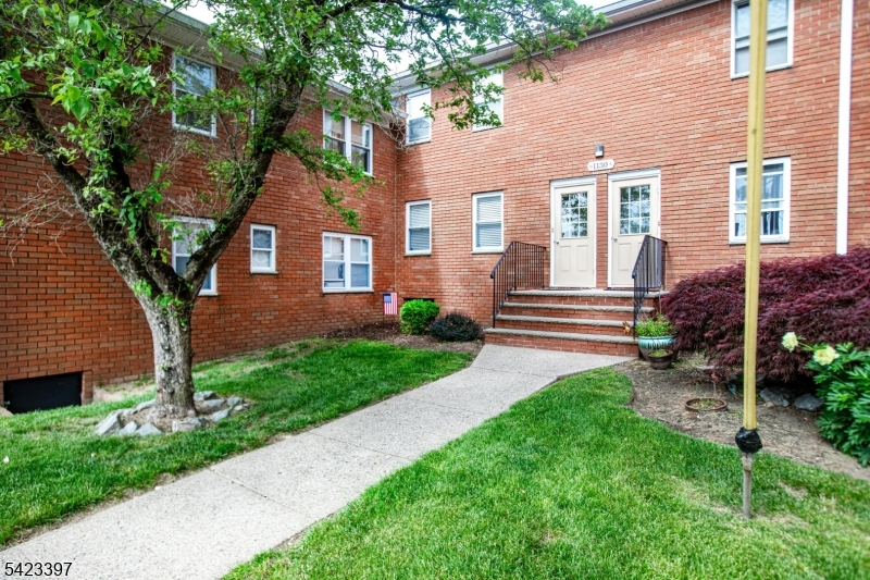 1130 Valley Road, Unit 2B Wayne, NJ 07470 - Photo 38 of 47 a view of a brick house with a yard and large tree