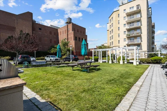 a view of a building with garden and sitting area