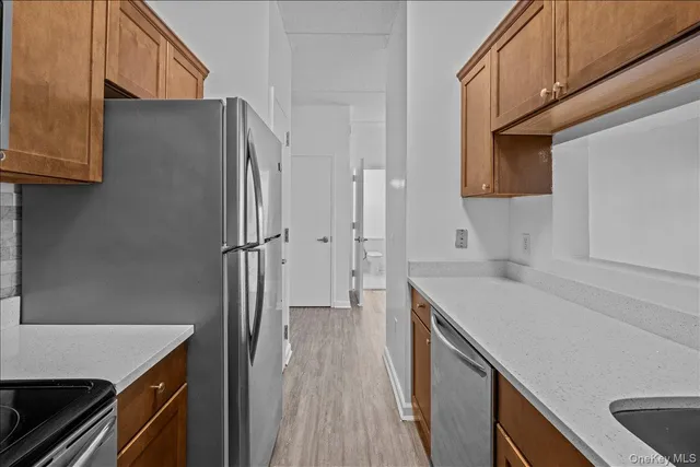 a kitchen with stainless steel appliances a stove a sink and a refrigerator