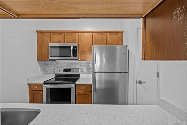 a kitchen with a refrigerator a stove top oven and a dishwasher