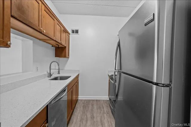 a kitchen with a sink and a refrigerator