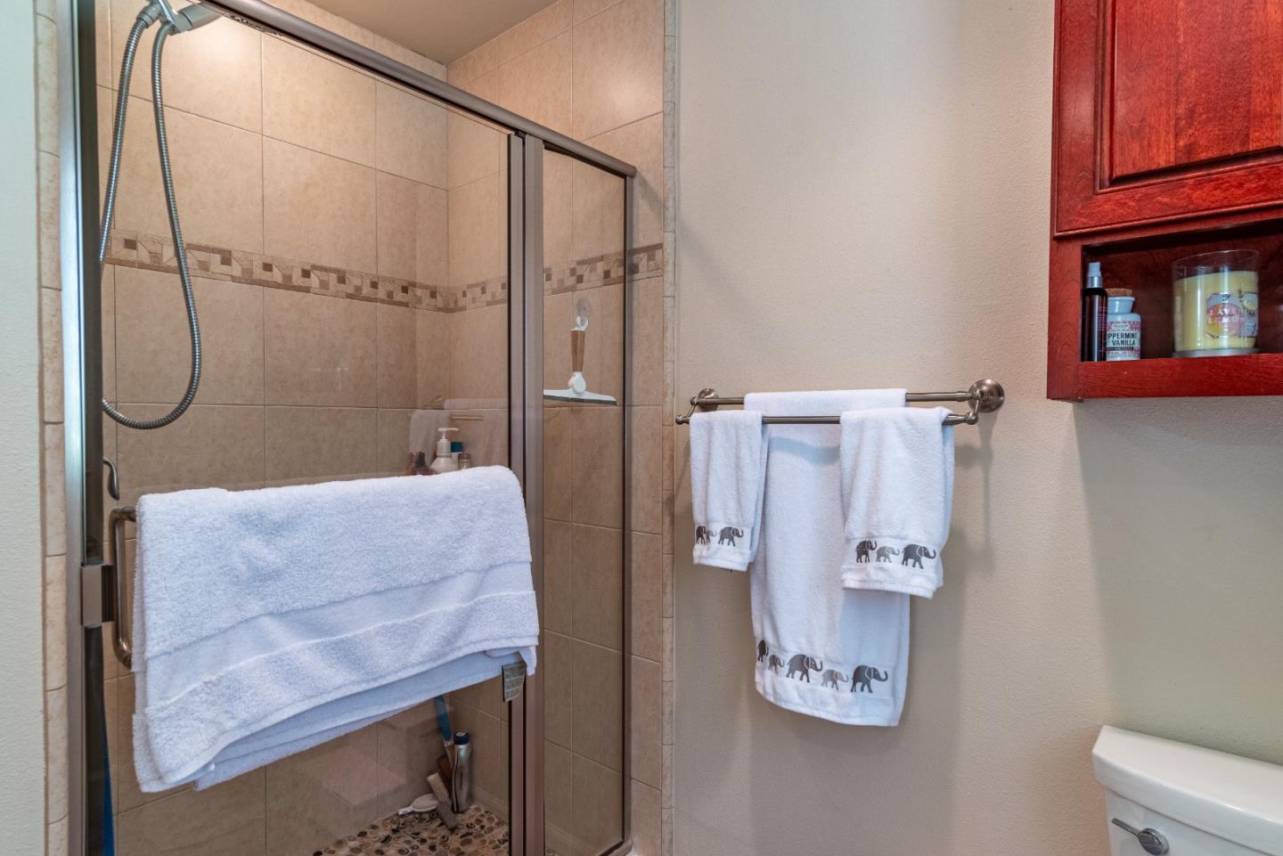 161 San Benancio Road Salinas, CA 93908 - Photo 21 of 44 a bathroom with a granite countertop shower a sink and a mirror