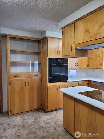 a kitchen with stainless steel appliances granite countertop a sink and a stove top oven