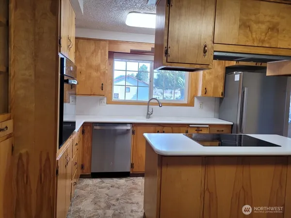 a kitchen with a sink and a refrigerator