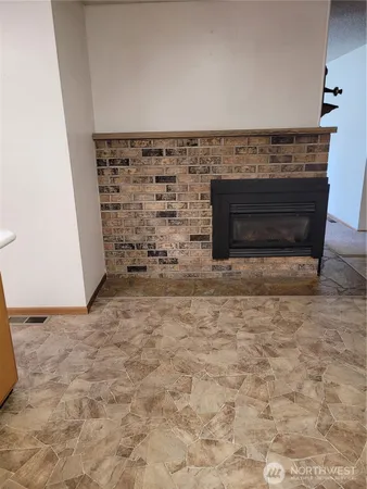 a view of empty room with a fireplace