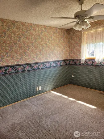 a view of a room with window and fan