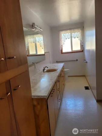 a bathroom with a sink a vanity and mirror