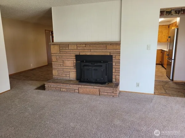 a view of an empty room with a fireplace