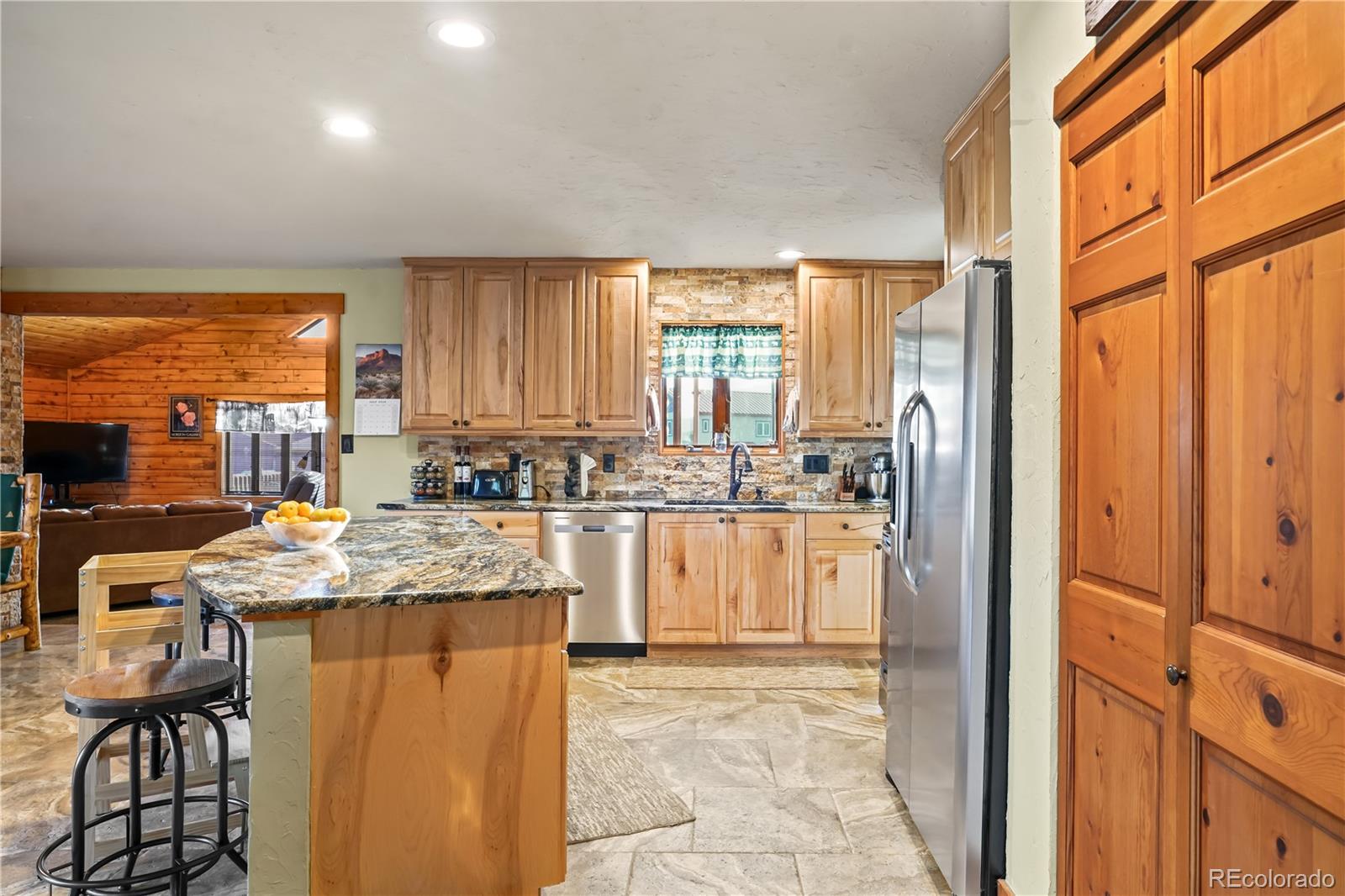 115 County Road 1014 Silverthorne, CO 80498 - Photo 4 of 20 a kitchen with stainless steel appliances granite countertop a stove a sink and a refrigerator
