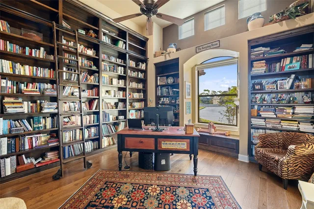 a room with pool table and windows
