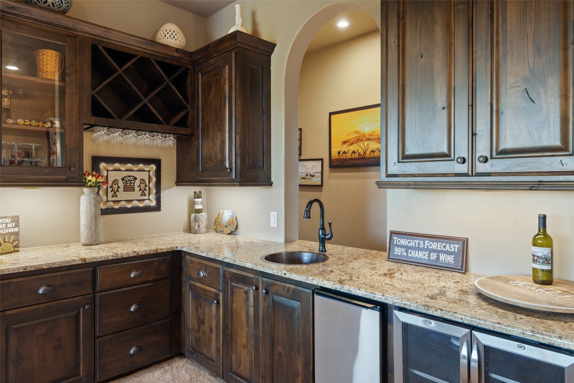 1039 Bluewater Place Spring Branch, TX 78070 - Photo 27 of 40 a kitchen with granite countertop a sink a stove and cabinets