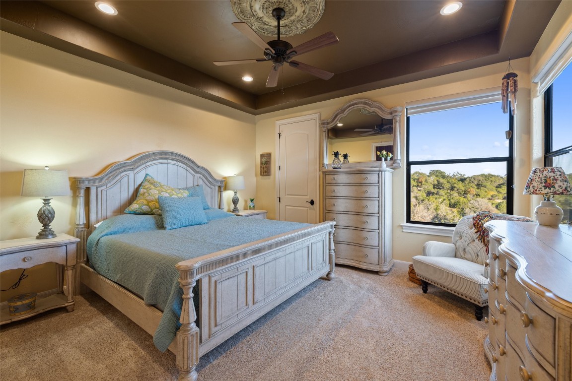 1039 Bluewater Place Spring Branch, TX 78070 - Photo 28 of 40 a bedroom with a bed and a chandelier