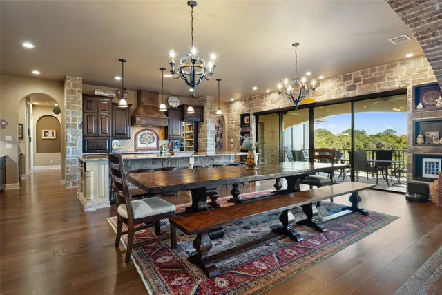a view of a balcony with chairs and wooden floor