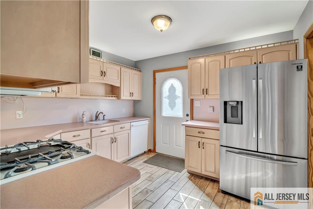 306 Austin Avenue Old Bridge, NJ 08857 - Photo 12 of 39 a kitchen with stainless steel appliances a refrigerator sink and stove